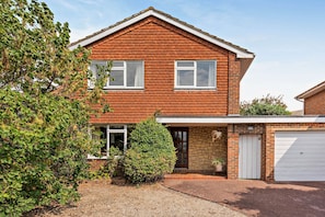 A two-story brick house with a garage, a front door, and a small garden area. - Host Stay Worthing Getaway (Worthing)