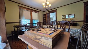 A dining area with a wooden table, chairs, and a chandelier. - Grand Victorian - Easy GAP Access, shops, and restaurants (Confluence)