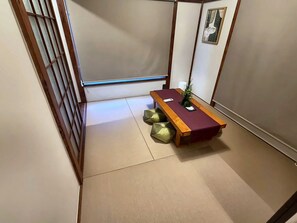 A traditional Japanese room with tatami flooring, a low wooden table, and a shoji screen. - MSTAY Oshiage One (Sumida-ku)