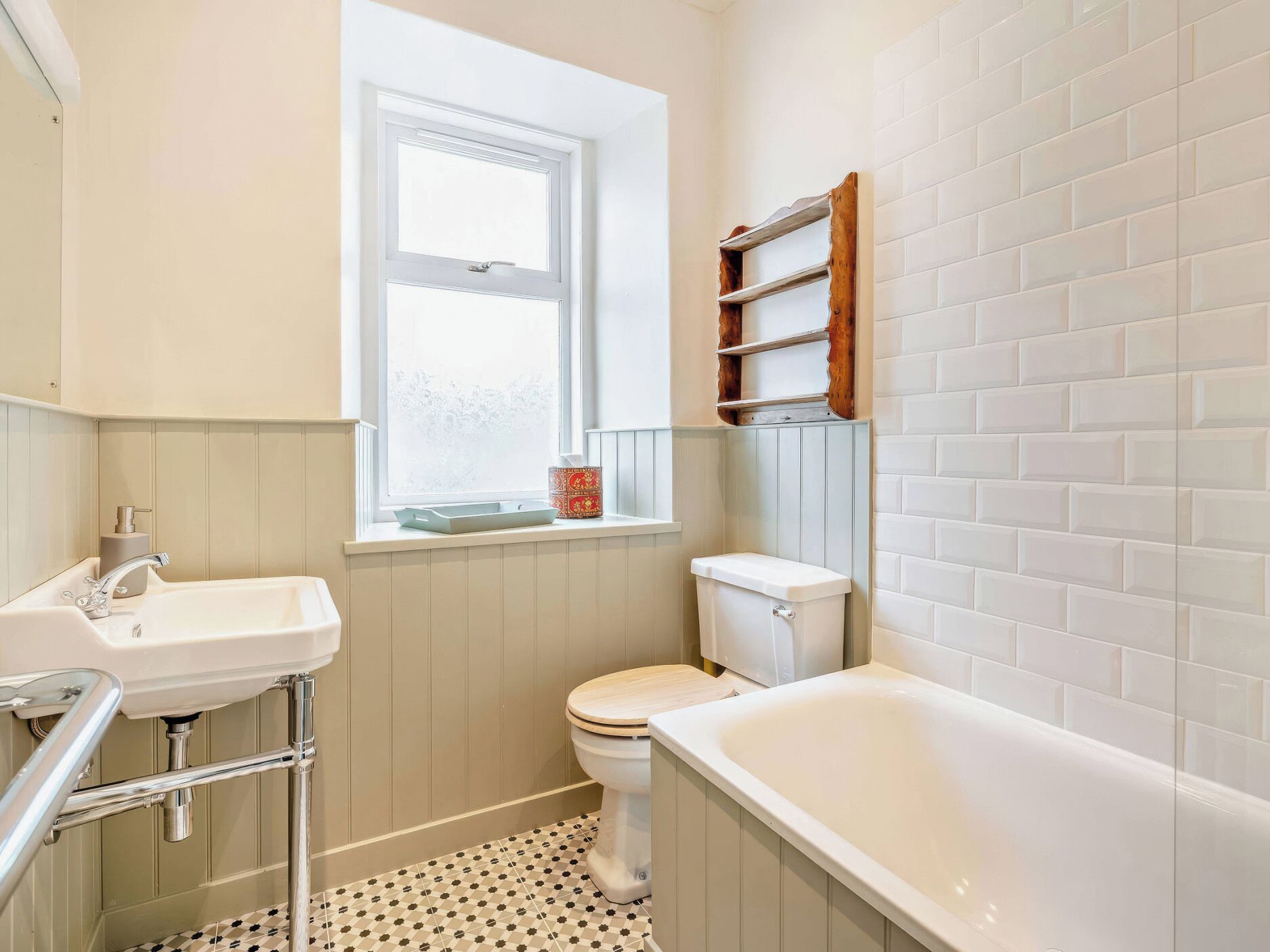 A bathroom with a white sink, a toilet, and a bathtub.