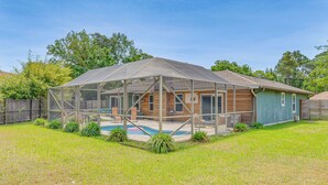 A house with a covered patio and a swimming pool. - Pool Days! Family Getaway Near Pensacola Beach (Gulf Breeze)