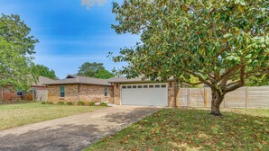 A residential property with a brick house, a garage, and a driveway leading to the entrance. - Pool Days! Family Getaway Near Pensacola Beach (Gulf Breeze)