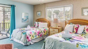 A hotel room with two beds, a ceiling fan, a window with blinds, and a view of the outside. - Lake-view Balcony, Pool Access! Sunset Beach Condo (Sunset Beach)