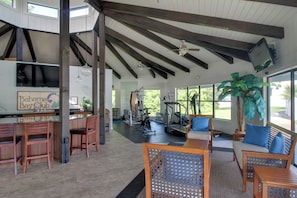 A spacious indoor area with a high ceiling, wooden beams, and a seating area with chairs and a table. - Private Patio, Yard! Townhome Near Pensacola Beach (Gulf Breeze)