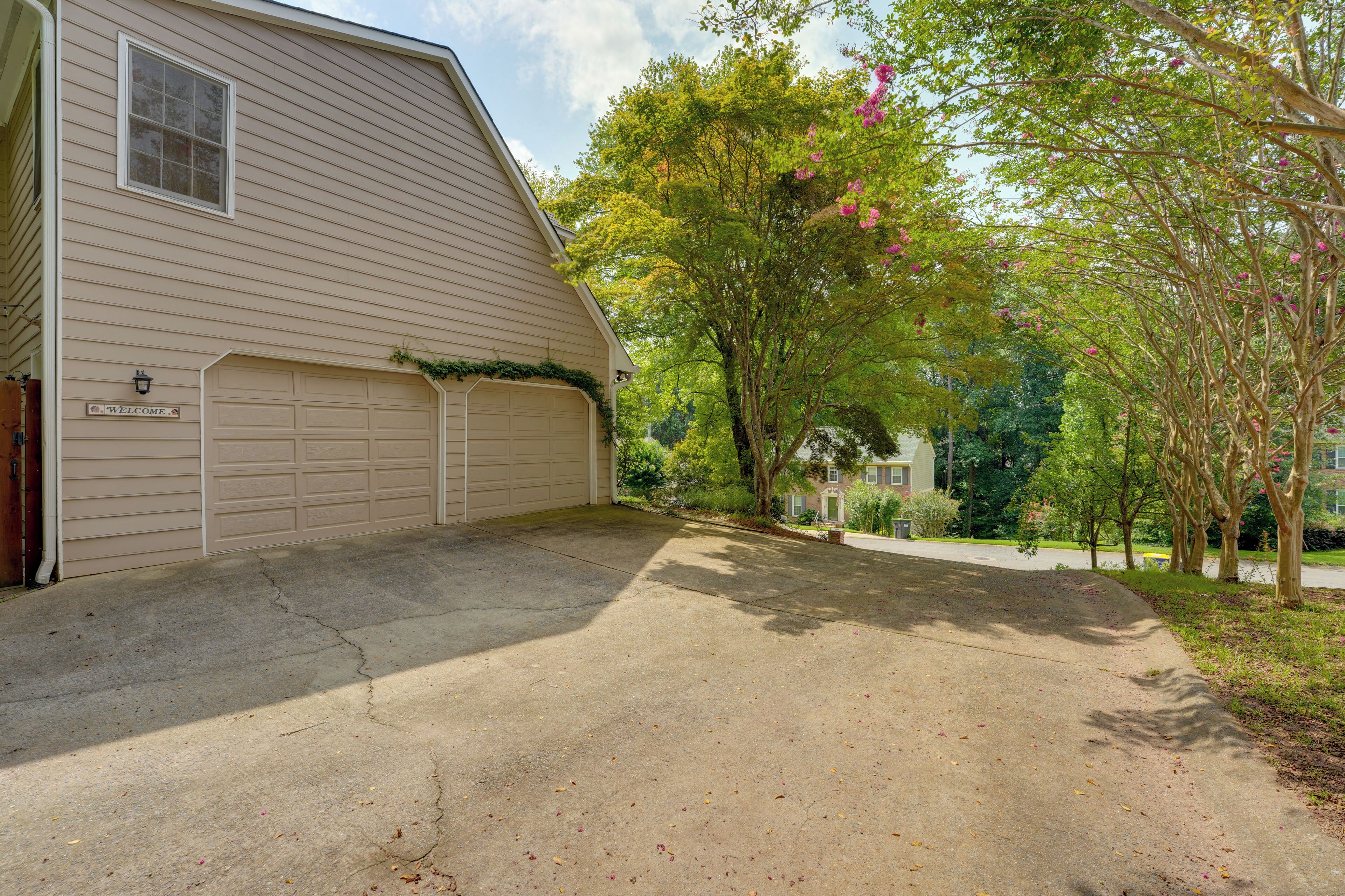 A residential property with a garage, a driveway, and a well-maintained lawn.