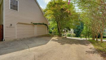 A residential property with a garage, a driveway, and a well-maintained lawn.