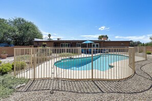 A swimming pool surrounded by a fence, with a building in the background. - 7 Mi to Saguaro Natl Park! Mtn-view Haven w/ Pool (Tucson)