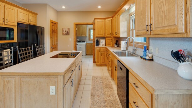 Una cocina moderna con armarios de madera, electrodomésticos de acero inoxidable y una isla grande.