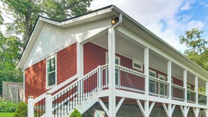 A two-story house with a covered porch and a staircase leading to the second floor. - Walk to Dtwn Waynesville! Dual Mtn Havens w/ Decks (Waynesville)