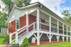 A two-story house with a covered porch and a staircase leading to the second floor. - Walk to Dtwn Waynesville! Dual Mtn Havens w/ Decks (Waynesville)