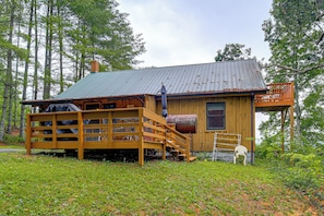 A rustic cabin with a wooden deck, a metal roof, and a staircase leading to a porch. - Rustic Cabin w/ Phoenix Mtn Views & Trail Access! (Lansing)