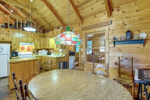 A wooden cabin interior with a kitchen, dining area, and a sign stating 'HOME IS WHERE THE HEART IS.' - Rustic Cabin w/ Phoenix Mtn Views & Trail Access! (Lansing)