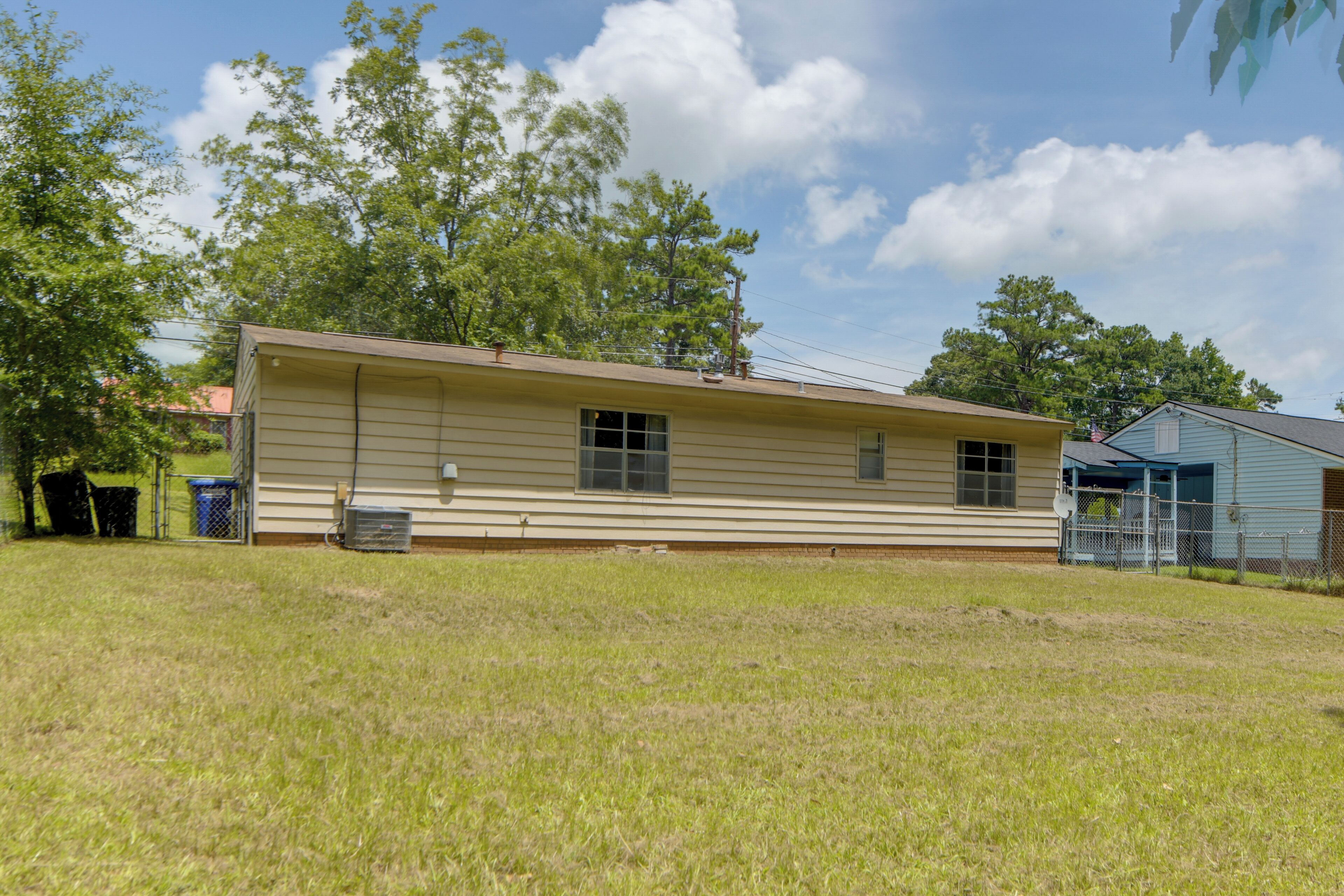 A single-story house with a flat roof, a front porch, and a small attached garage.