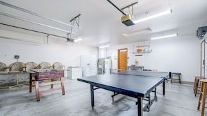 A spacious room with a ping pong table, chairs, and a foosball table. - Lake Roosevelt Retreat Lake: Mtn Views, Game Room (Davenport)