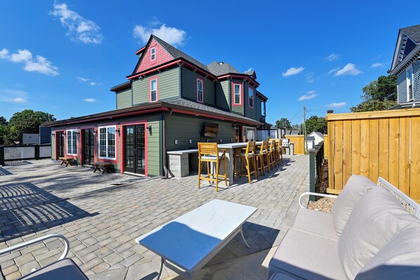 A patio area with outdoor seating and a barbecue grill.