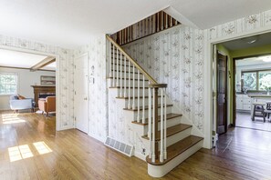 A staircase with wooden steps and white balusters, leading to an upper floor. - Perfect Family Retreat: Pool, Fire Pit (Westfield)