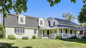 A two-story house with a porch and a covered front porch area. - Perfect Family Retreat: Pool, Fire Pit (Westfield)