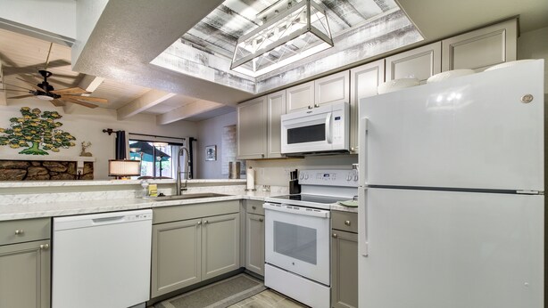 A modern kitchen with white appliances, a dishwasher, an oven, and a refrigerator. - Great for Families! Pinetop Sanctuary w/ Patio (Pinetop)