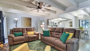 A spacious living room with two brown leather sofas, a coffee table, and a ceiling fan. - Great for Families! Pinetop Sanctuary w/ Patio (Pinetop)