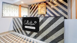 Ein Empfangsbereich mit Schilder, die Dienstleistungen anbieten, einer strukturierten Wand und einem Schild für Check-in und Check-out.