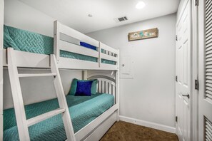 A bunk bed room with a door and a sign on the wall. - 19th Floor Gulf Views | 2 King Suites | Splash Resort East Tower (Panama City Beach)