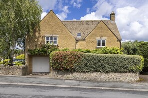 A two-story stone house with a white door and a small window on the ground floor. - Birch House -  a cottage that sleeps 8 guests  in 4 bedrooms (Stow-on-the-Wold)