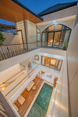 A multi-level interior with a pool, wooden flooring, and a staircase. - 3BR Umalas Villa • Pool & Rooftop Terrace • Scooter & Restaurant discounts (Kuta Utara)