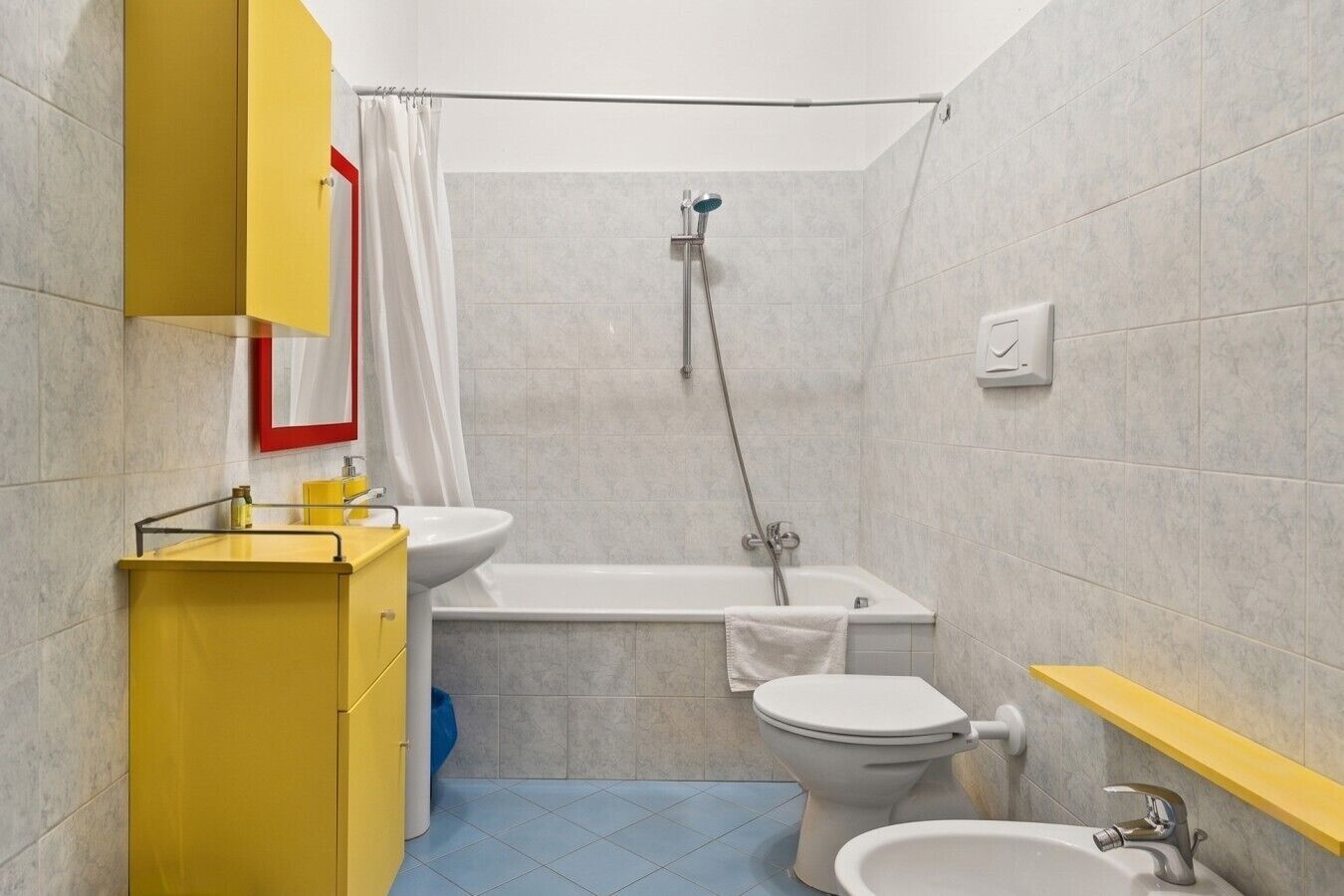 A bathroom with a bathtub, toilet, and sink.