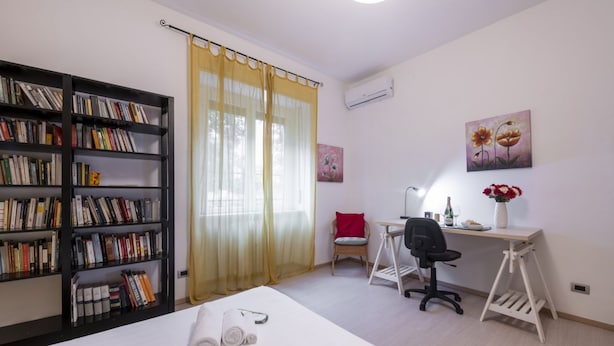 A bedroom with a bed, a desk, a chair, a bookshelf, and a window with curtains. - STRAMBIO, 8 – Smart Stay in Milan (Milano)
