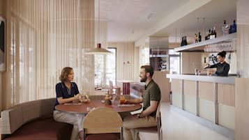 A modern interior with a bar area, seating, and a view through the window.