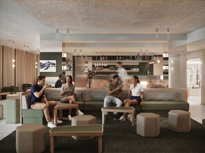 A modern lounge area with seating arrangements, a bar area with bottles, and a wall-mounted artwork.