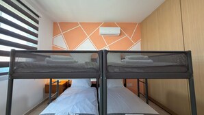 A twin room with two beds, a wardrobe, and a window with blinds. - Family Resort Apt with Pool Sleeps 6 (Paralimni)