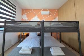 A twin room with two beds, a wardrobe, and a window with blinds. - Family Resort Apt with Pool Sleeps 6 (Paralimni)