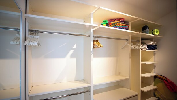 A walk-in closet with open shelves, a hanging rod, and a folded clothes rack. - Villa Lara With Pool Walk To Sea (Medulin)