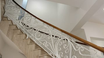 A staircase with ornate white railings and wooden handrails.