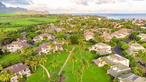 A residential area with houses, palm trees, and a view of the ocean. - Kauai Regency At Poipu Kai #823 3 Bedroom Condo (Koloa)