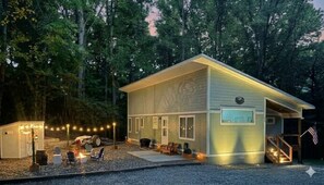A two-story house with a covered porch, a small shed, and a fire pit area. - Murray Creek Hollow - Private Asheville Escape (Asheville)