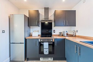 A modern kitchen with a built-in oven, a microwave, and a stove.