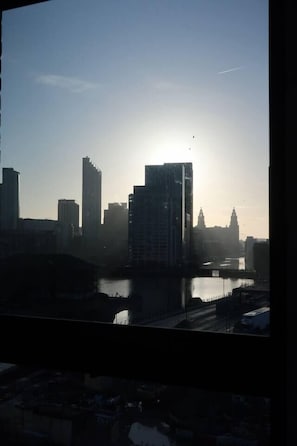 A cityscape with high-rise buildings, a river, and a bridge. - #132 Stylish Luxury Flat | Free Parking |City View (Merseyside)