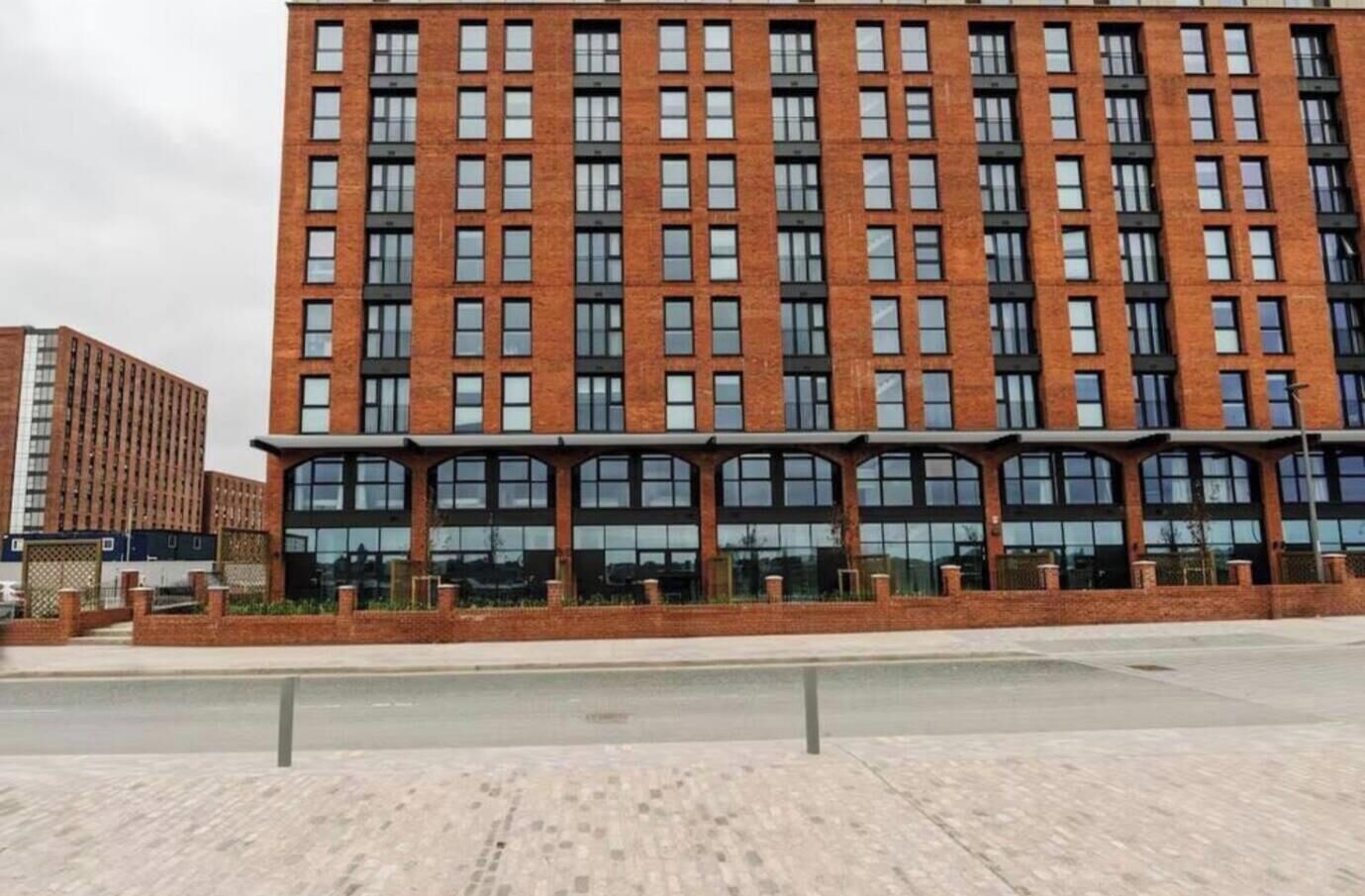 A multi-story building with a brick facade and large windows.