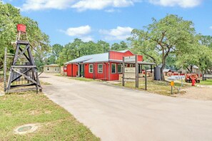 A red building with a sign indicating a law firm and vintage logging. - Wimberley Firehouse | Private Hot Tub Near Wimberley Square (Wimberley)