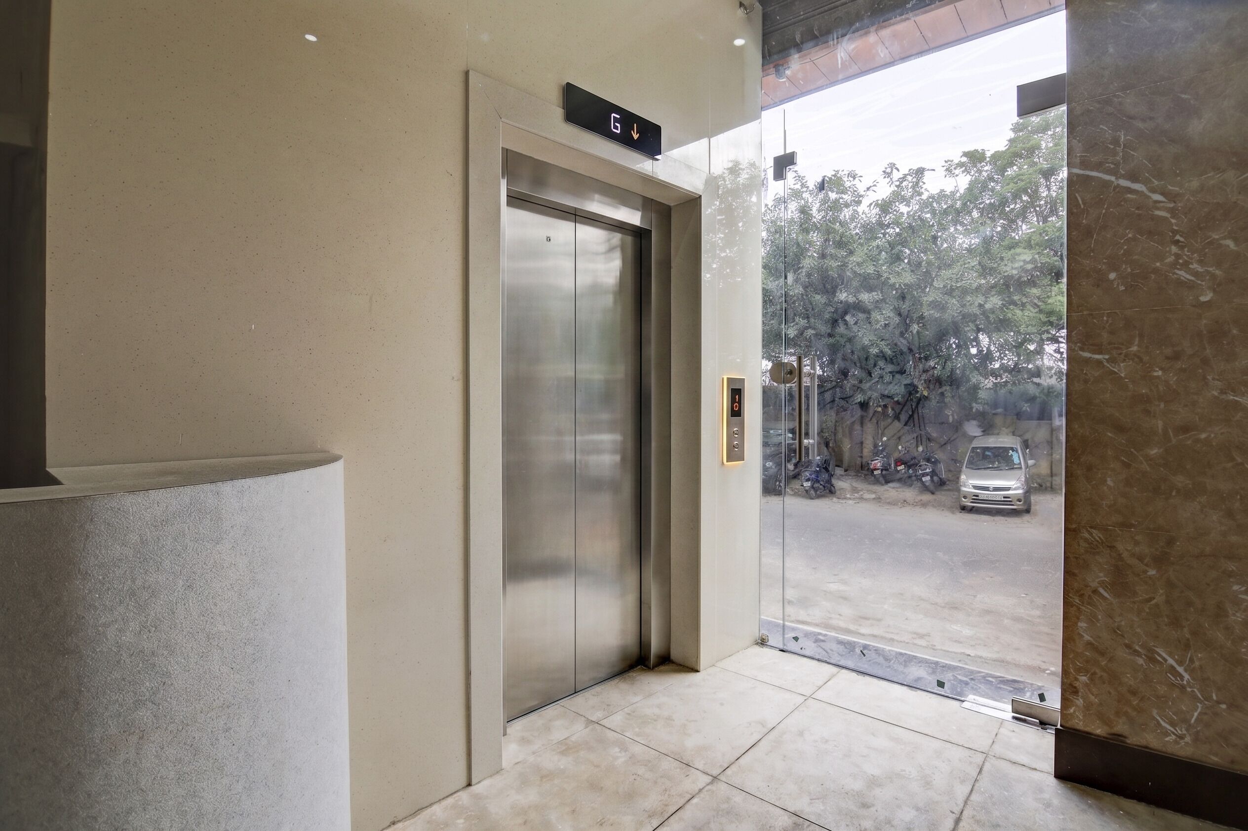 An elevator with a digital display indicating the ground floor.