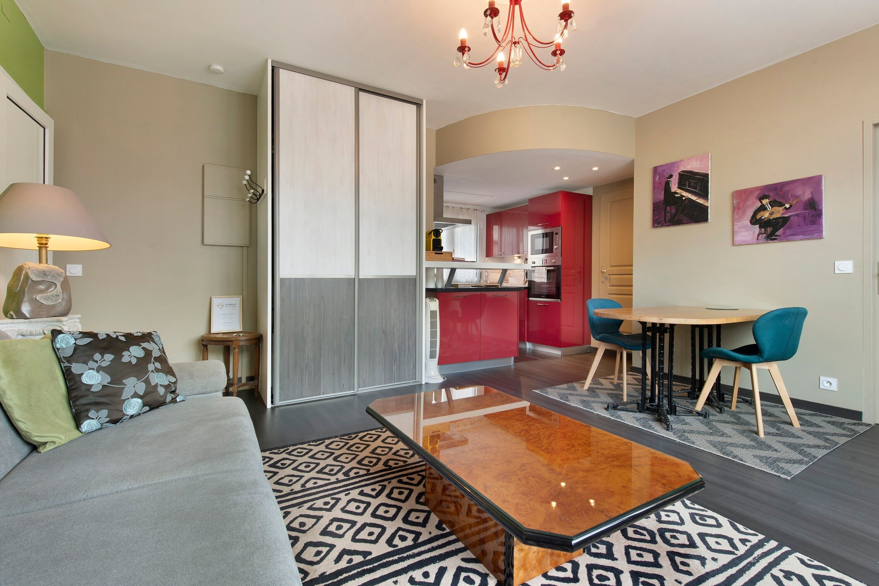 A modern living room with a sofa, a coffee table, and a dining area with chairs.