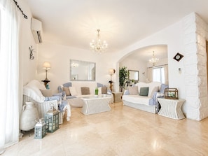 A spacious living room with two sofas, a coffee table, and decorative items. - The Elegant Hyacinth Flat (St. Paul`s Bay)