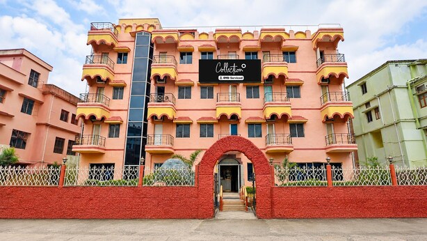 A multi-story building with a prominent entrance, balconies, and a sign indicating it is serviced by OYO. - Classic Hotel Bidisha (Kanthi)
