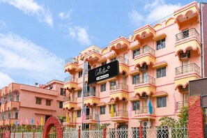 A multi-story building with balconies and a sign indicating it is serviced by OYO. - Classic Hotel Bidisha (Kanthi)