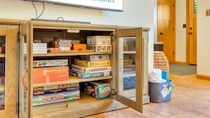 A wooden game cart with various board games and puzzles. - Pelican Perch by Manzanita Beach Getaway- Walk to Beach & Downtown, Dog-Friendly (Manzanita)