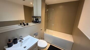 Combined shower/bathtub, deep-soaking bathtub, towels