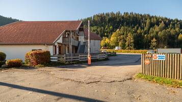 A building with a sloped roof, a wooden fence, and a sign indicating private property.