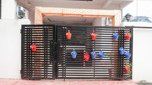 A gated entrance to a building with a sign reading 'ROOMS BANQUET RESTAURANT' above. - Classic Lucknow Inn (Lucknow)